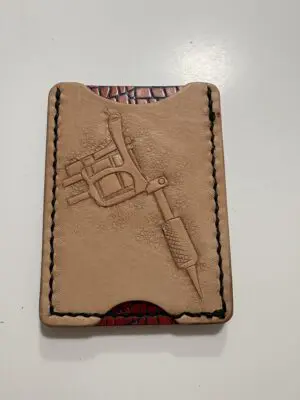 Leather card holder with tattoo machine design.